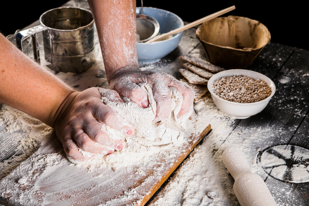 baker kneading-dough with flour 